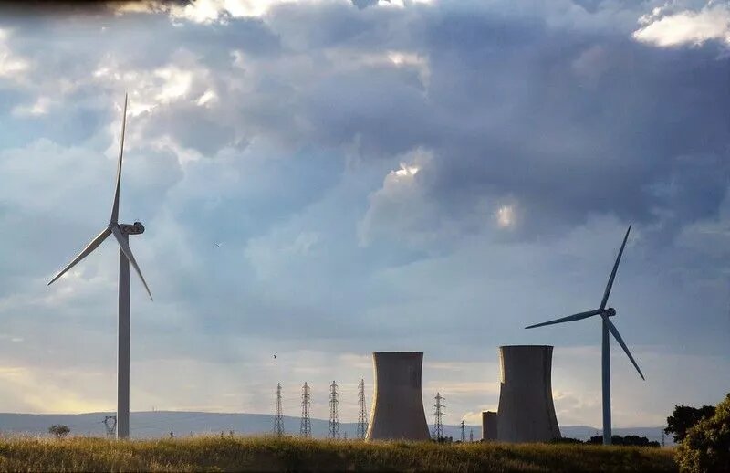 old nuclear power plant & new wind turbine old nuclear power plant & new wind turbine
