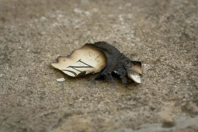 burned scrap of newspaper Wolność mediów