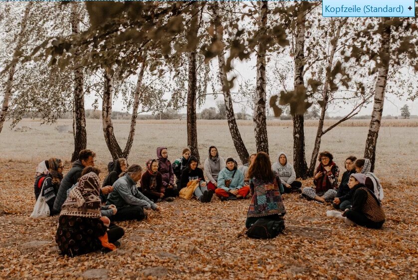 Road trip: Group of young people sitting and discussing under trees