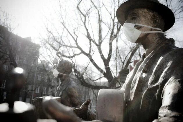 Monument of a traditional Warsaw music band with dust-protection masks Monument of a traditional Warsaw music band with dust-protection masks