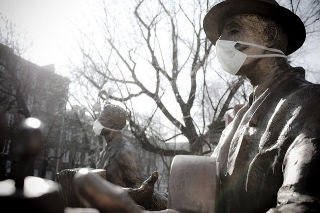 Monument of a traditional Warsaw music band with dust-protection masks Monument of a traditional Warsaw music band with dust-protection masks