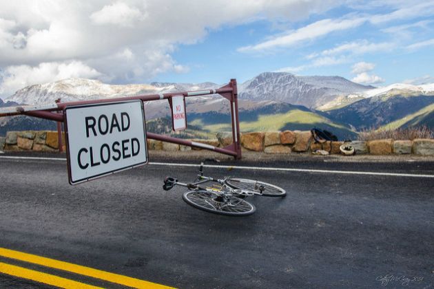 Rower leżący na ulicy przed znakiem "road closed"